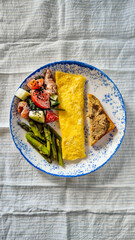 continental breakfast, omelet, vegetables and toast, no people, top view