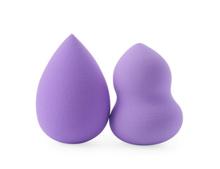 Two violet makeup sponges isolated on white