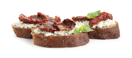Delicious ricotta bruschettas with sun dried tomatoes and basil isolated on white