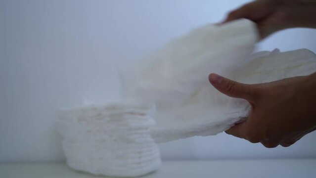 Diapers for the baby. Hands take diapers