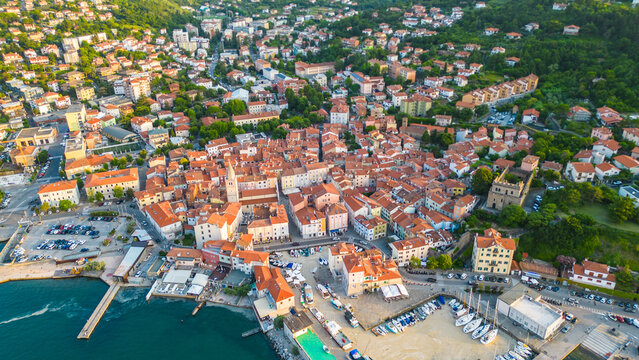 An aerial sunset view of the charming town of Muggia in Friuli Venezia Giulia, Italy with white mucilaginous blooms blanket. This picturesque town, located near the border with Slovenia 