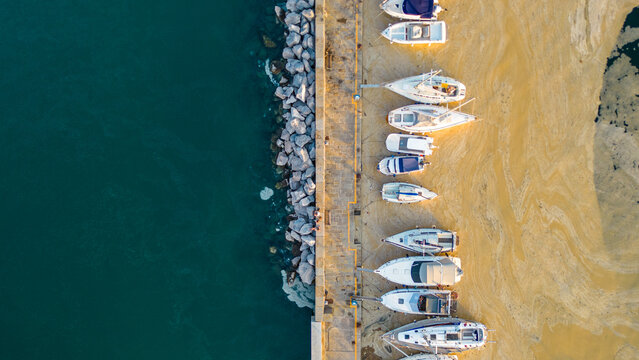 An aerial sunset view of the charming town of Muggia in Friuli Venezia Giulia, Italy with white mucilaginous blooms blanket. This picturesque town, located near the border with Slovenia 