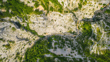An aerial view of the stunning Val Rosandra Nature Reserve, showcasing its beautiful hiking trails that wind through lush greenery and rugged landscapes. Located near Trieste, Italy