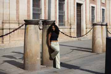 beautiful young latin woman with black and dark eyes and long curly hair with a sad expression...