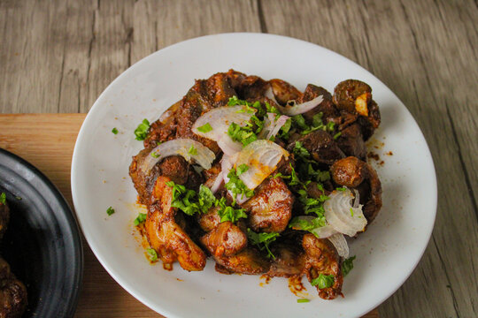 Chicken gizzard and liver cooked in Indian style. Garnished with the freshly chopped onion and coriander. 