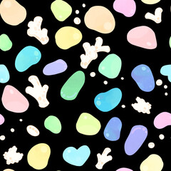 colorful sea glass and polished stones with white coral on dark background