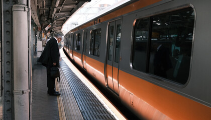 Old man wait for train in Shinjuku station. Aging population increase year by year, they call the old people as Silver-haired people which have higher income but mostly retired