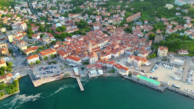 An aerial sunset view of the charming town of Muggia in Friuli Venezia Giulia, Italy with white mucilaginous blooms blanket. This picturesque town, located near the border with Slovenia 