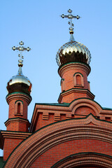 Beautiful summer view of an old Ukrainian church. Brick building with pinnacles and towers