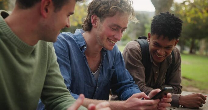 Friends, outdoor and men laughing with phone for online joke, social media and funny conversation. Comedy meme, gen z people and guys with mobile in park or gossip website and talking for silly story