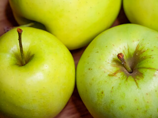 Brightly lit green apples, suggesting health and vitality, likely used in dietary content.