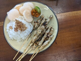 Indonesian Chicken Satay taican with Rice and Sambal. A plate of Indonesian chicken satay, served...