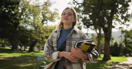 Happy woman, student and walking with books in nature for learning, education or path to university. Female person in stroll with textbooks at outdoor forest, campus or college for academic journey