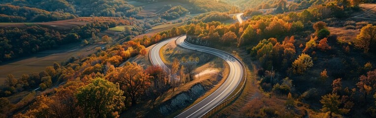 Aerial View of Highway Curving Through Autumn Hills