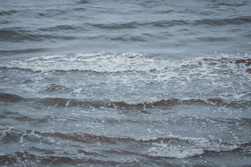 Upper seaside view with waves forming near costal line.