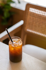 Iced coffee with latte in a glass cup. Cold summer drink.