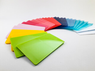 Fototapeta premium Stack of assorted color chips, isolated on a white background. This is an example of the colors produced by masterbatch in plastic products.