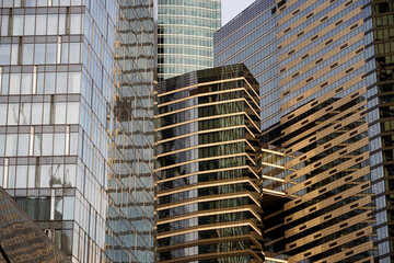 Fragment of the facades of modern buildings. Skyscrapers made of glass and steel. Design in modern construction.