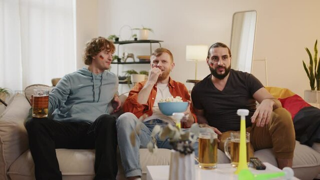 German fans watching football match on tv and eating snacks, cheering for Germany team. European Germany and World football cup 2026 USA, Canada, Mexico. Sports and soccer fans. Slow Motion