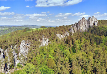Rocky ridge on the hill above the forest, wild landscape