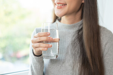Happy beautiful, asian young woman, girl drinking, sip fresh glass of water for hydration of body,...