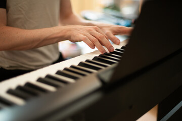 Fototapeta premium Close-up of Hands Playing an Electric Piano