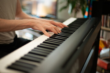 Fototapeta premium Close-up of Hands Playing an Electric Piano