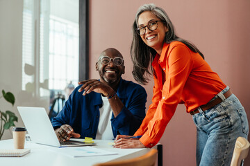 Happy colleagues in a modern office having a cheerful discussion