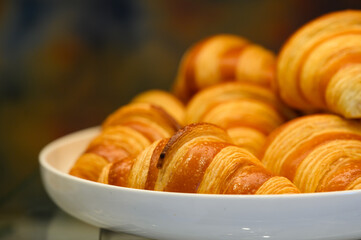 Homemade mini croissants on white plate in buffet line. Fresh Baked Buttery Croissants.
