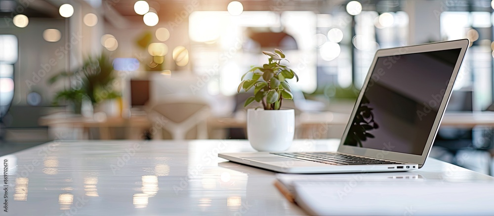 Poster close-up of white table with computer gadget and copy space image in blurred backdrop.