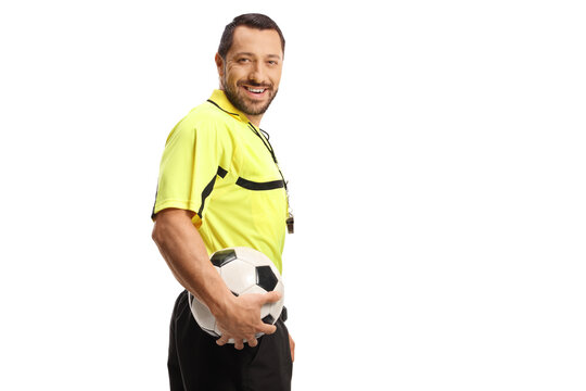 Referee holding a football and smiling at camera