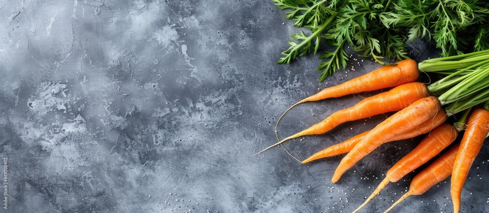Poster a healthy eating concept featuring fresh carrots on a gray background, creating a frame of vegetable