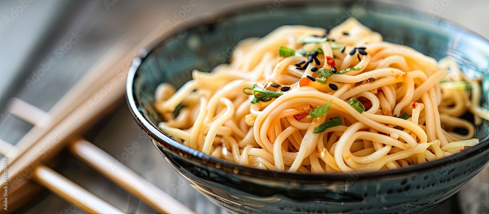 Poster bowl of noodles drizzled with soy sauce, with a background of a clear space for adding additional el