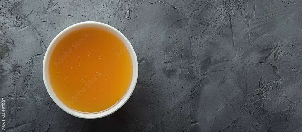 Aufkleber A nourishing bowl of broth on a gray background seen from above, creating an ideal layout for adding a picture or text, suitable for a banner design.