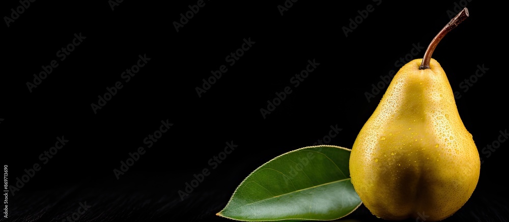 Poster ripe pear against black backdrop with copy space image.