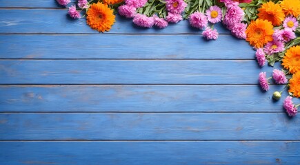 Beautiful flowers forming a border on a rustic blue wooden background