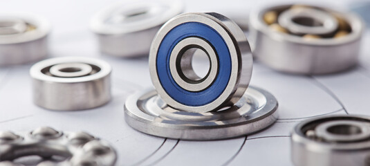 different bearings on blue print background. Part of mechanism.