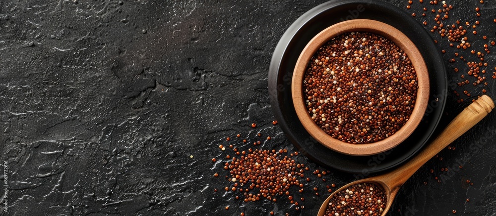 Poster Red quinoa superfood displayed from a top view on a black background with ample copy space image available.