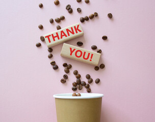 Thank you symbol. Wooden blocks with words Thank you. Beautiful pink background with coffee cup. Business and Thank you concept. Copy space.