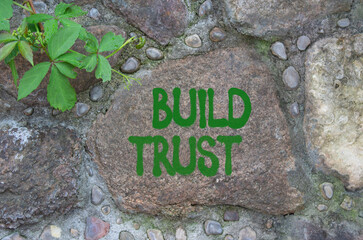 Build trust symbol. Stone wall with words Build trust. Beautiful stone background. Business and...