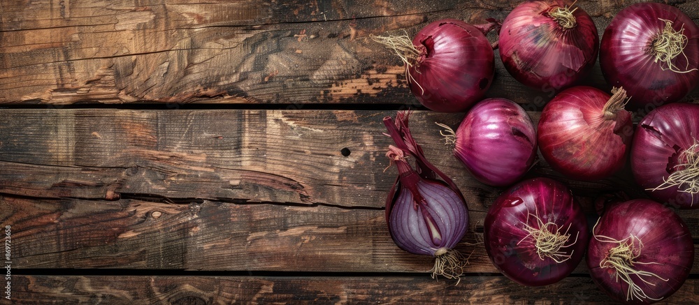 Aufkleber red onions displayed on a vintage wooden surface with copy space image.