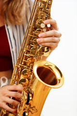 Fototapeta premium detail of woman's hands playing saxophone