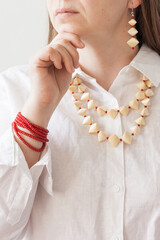 Lutsk, Ukraine - May 16 2024: A girl with a red beaded bracelet and straw necklace