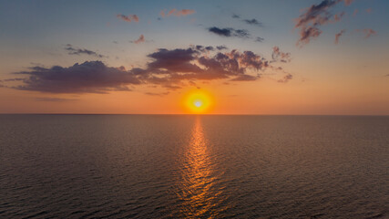 Panoramic Sunset aerial of open water with sun setting in the distance