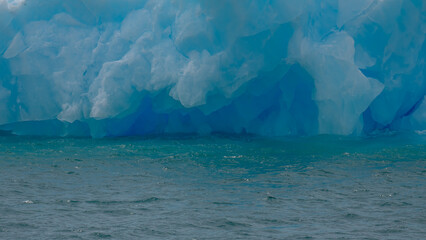 Blue Frozen Iceberg in Water Close Up Nature Details Antarctica Background Wallpaper. Blue...