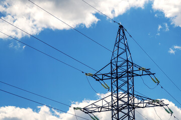 metal high-voltage support structure with wires against a cloudy sky, symbolizing power distribution, technology, and industrial infrastructure in the backdrop of the atmospheric sky