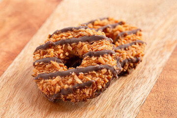 Sweet and Sticky Coconut Caramel Fudge Striped Cookies on a Wooden Table