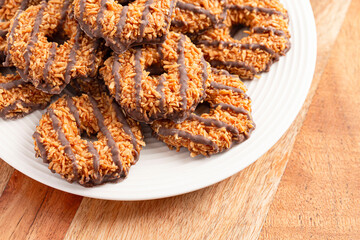 Sweet and Sticky Coconut Caramel Fudge Striped Cookies on a Wooden Table