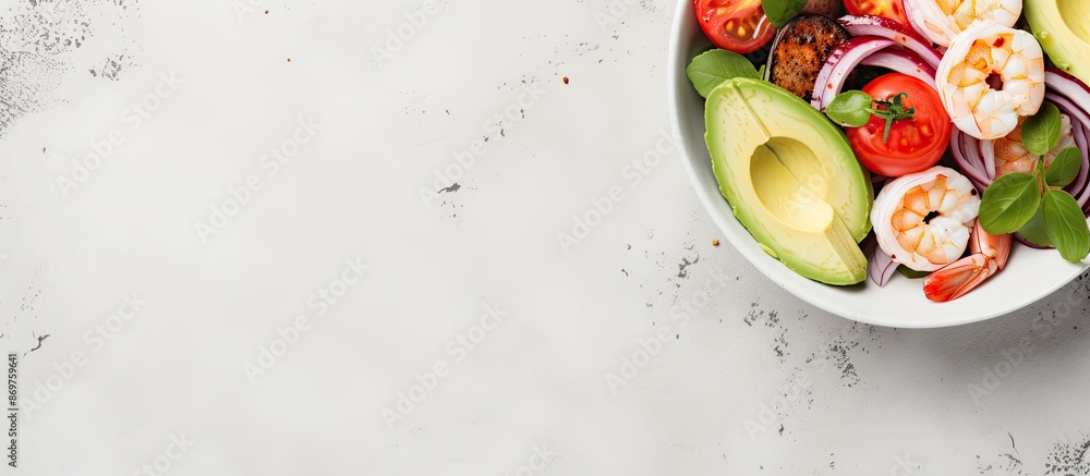 Poster close-up of a salad bowl containing avocado, prawns, tomato, and mozzarella on a light stone backdro
