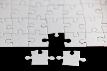 A puzzle piece is missing from a puzzle. Concept of loss and emptiness, as the puzzle is incomplete without the missing piece